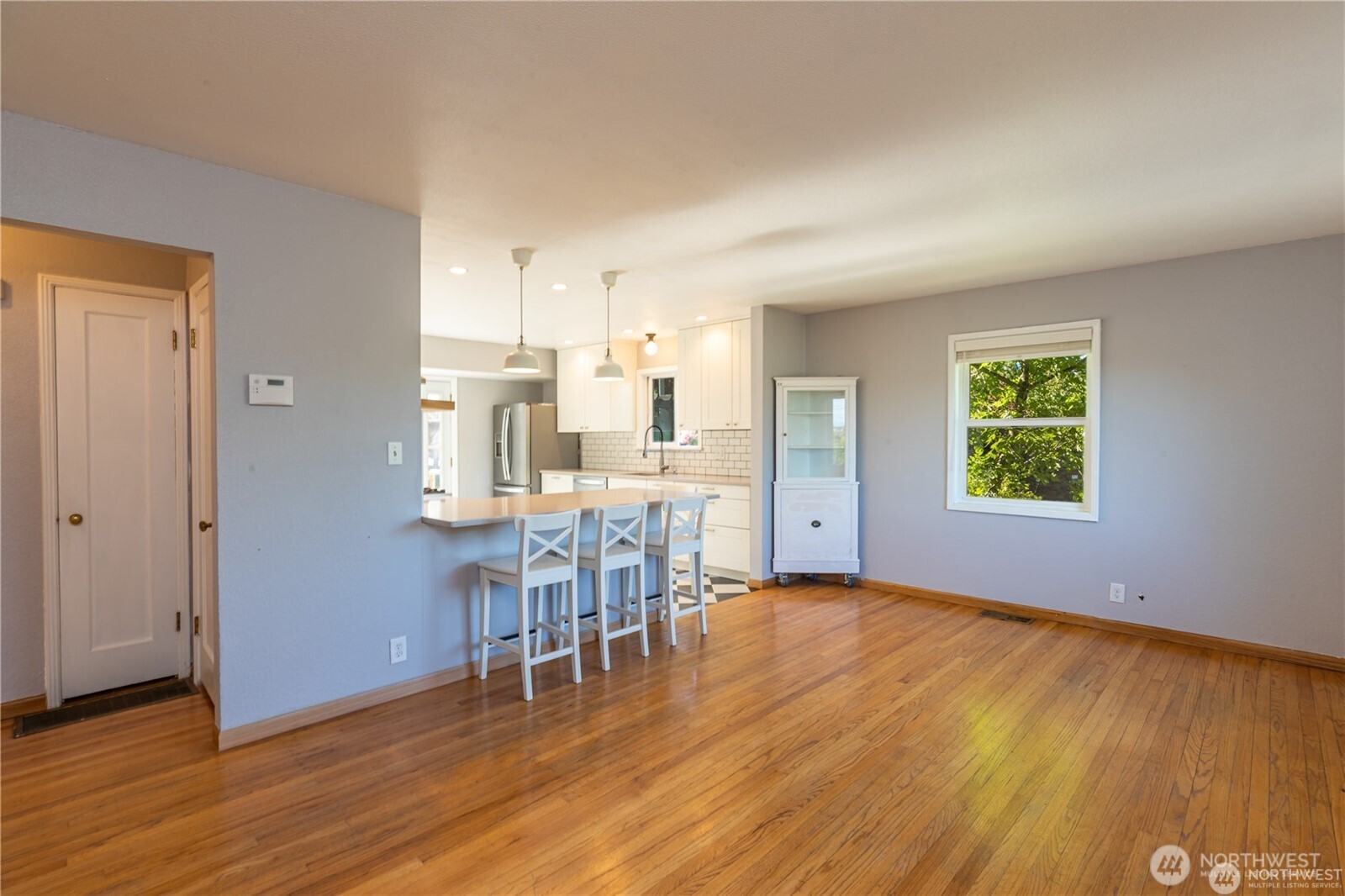 8601 36th Avenue Southwest Seattle, WA 98126 - Photo 4 of 28 a view of a kitchen with furniture and wooden floor
