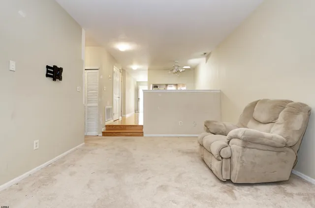 a view of livingroom with furniture and a bathroom