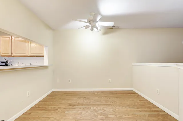 a view of a room with wooden floor and cabinet