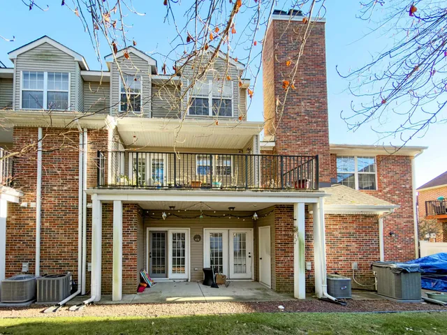 a front view of a residential apartment building with a yard