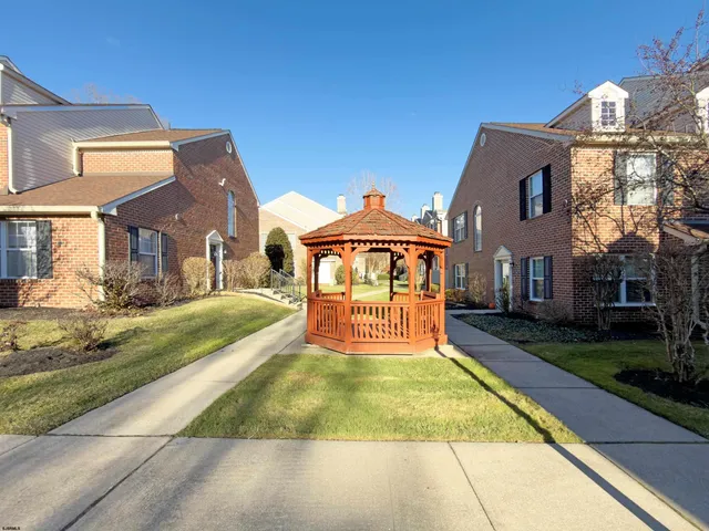 a view of house with yard and entertaining space