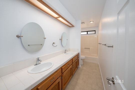 318 Reese Street Ridgecrest, CA 93555 - Photo 10 of 34 a bathroom with a double vanity sink mirror and bathtub