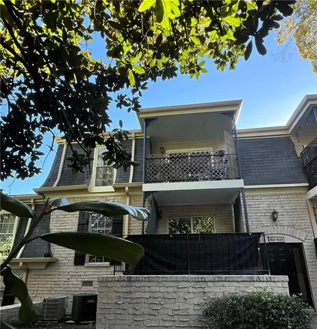a front view of a house with plants