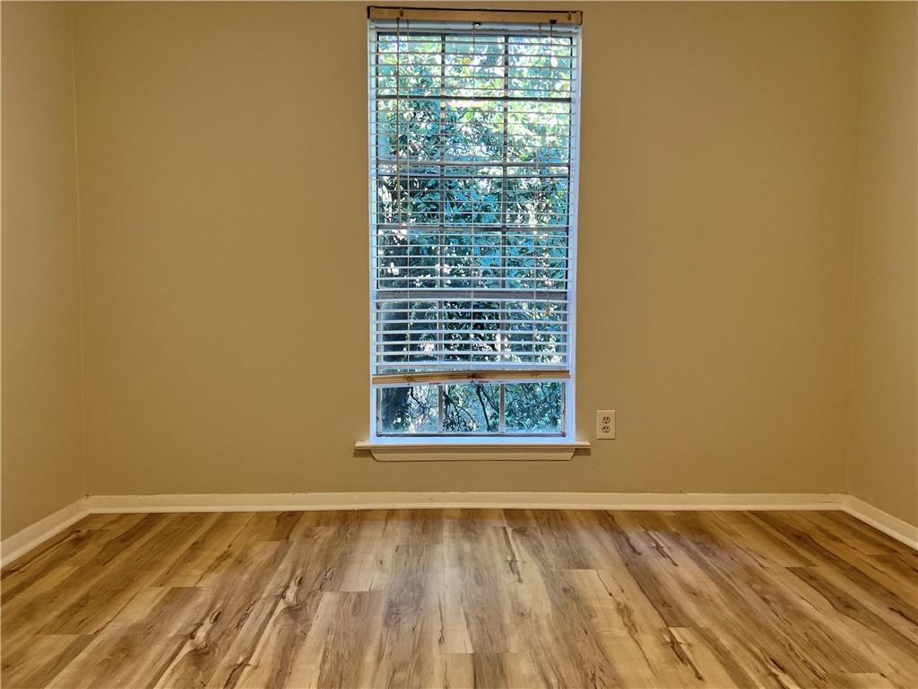 2805 Northeast Expressway Northeast, Unit B13 Atlanta, GA 30345 - Photo 11 of 69 a view of an empty room with wooden floor and a window