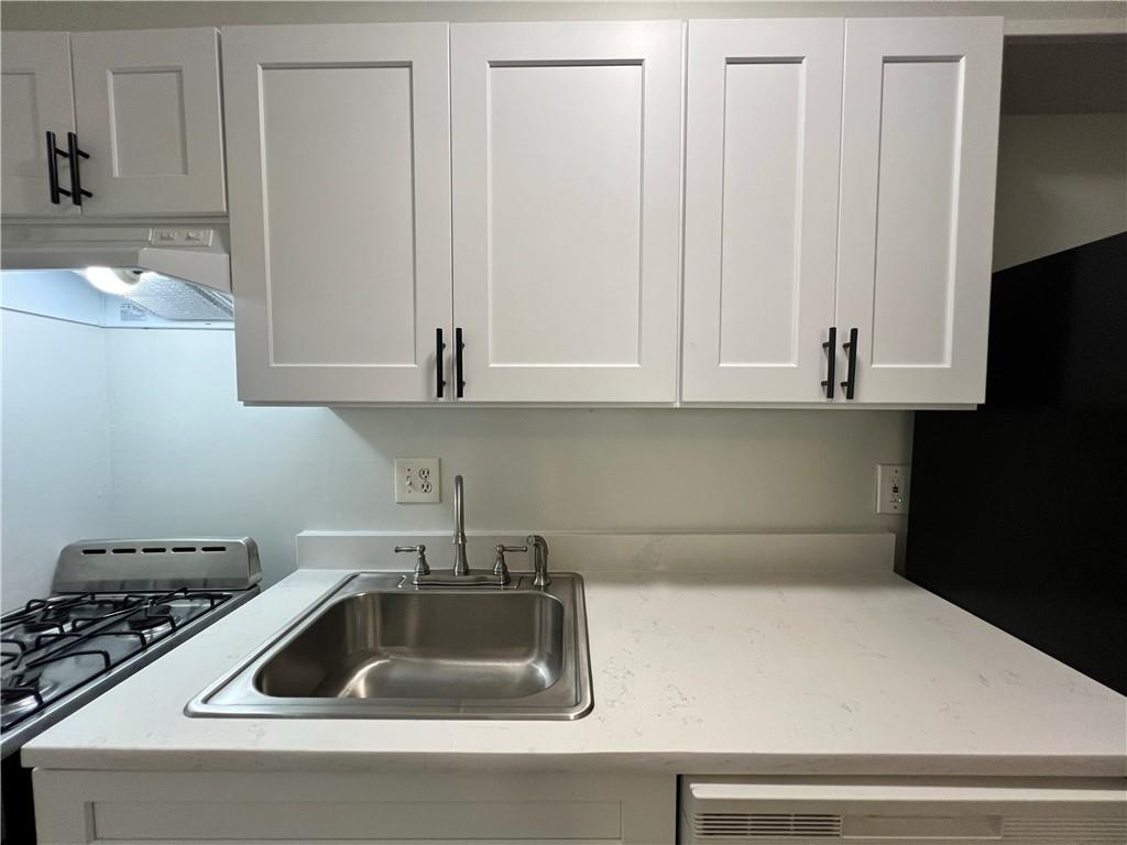 2805 Northeast Expressway Northeast, Unit B13 Atlanta, GA 30345 - Photo 37 of 69 a kitchen with a sink and cabinets