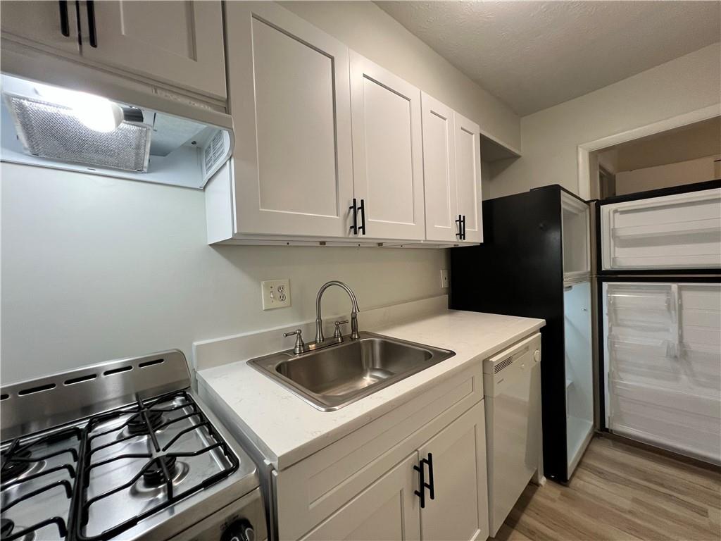 2805 Northeast Expressway Northeast, Unit B13 Atlanta, GA 30345 - Photo 38 of 69 a kitchen with a sink and a refrigerator