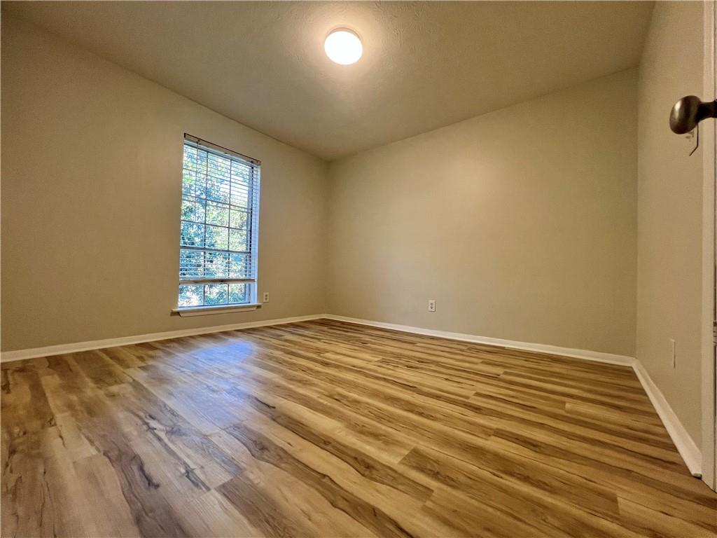 2805 Northeast Expressway Northeast, Unit B13 Atlanta, GA 30345 - Photo 10 of 69 an empty room with wooden floor and windows