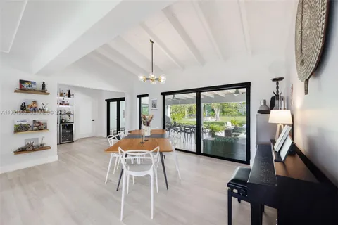 a work room with furniture and a floor to ceiling window