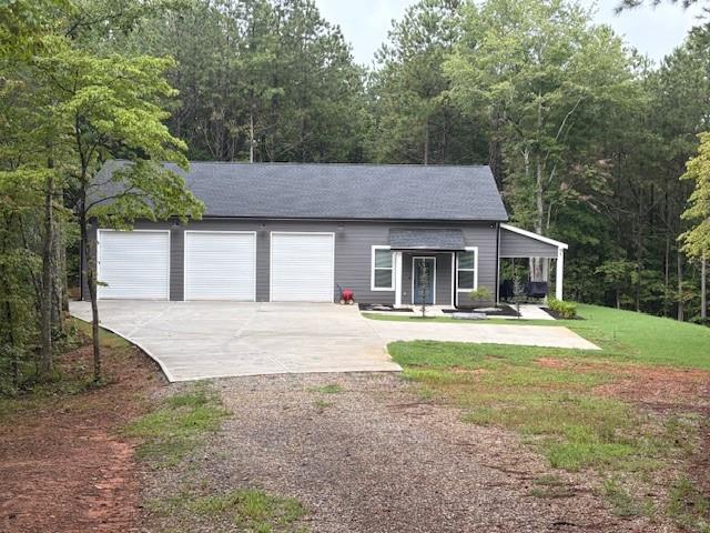 3199 Big Ridge Road Talking Rock, GA 30175 - Photo 10 of 25 a front view of a house with a garden and trees