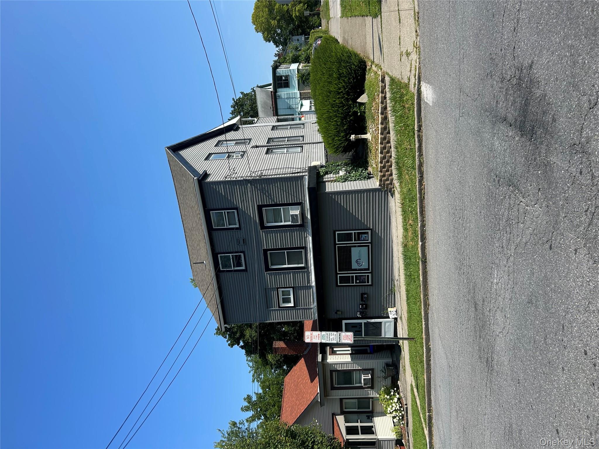 a front view of a house with a yard table and chairs