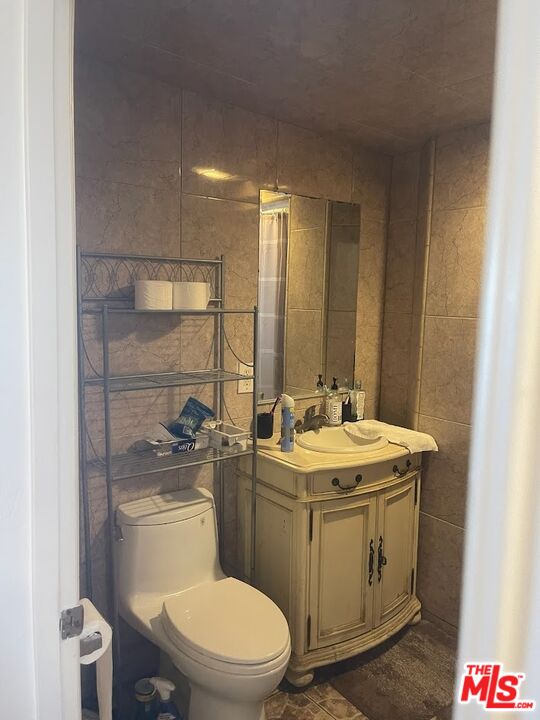 6908 Geyser Avenue Reseda, CA 91335 - Photo 6 of 6 a bathroom with a toilet sink and mirror