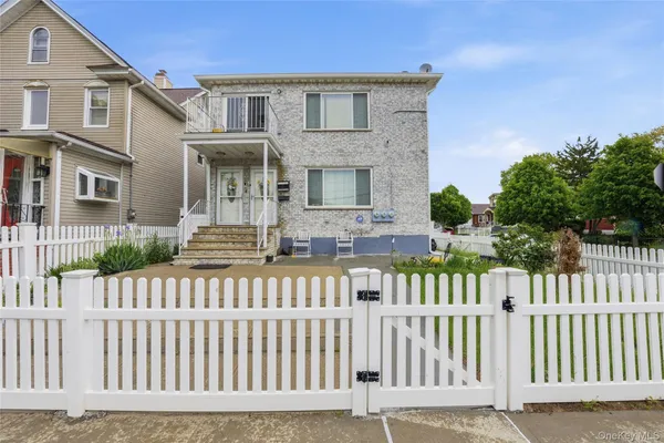 a front view of a house with a fence