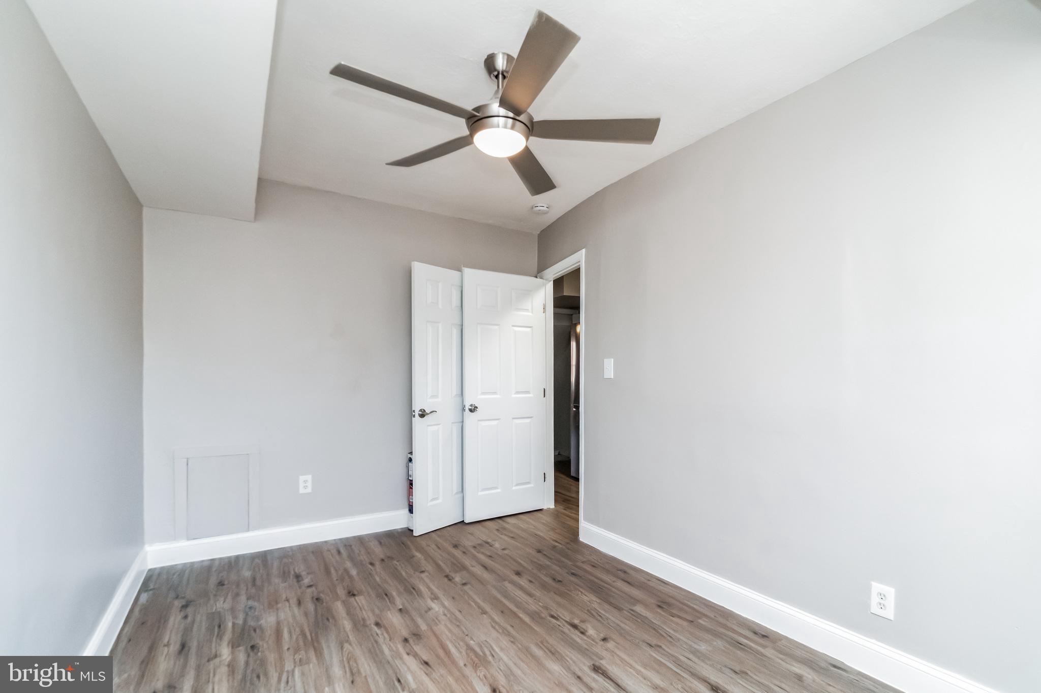 1515 First Street Southwest Washington, DC 20024 - Photo 14 of 37 an empty room with wooden floor ceiling fan and windows