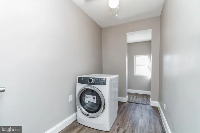 a view of a hallway with a washer and dryer