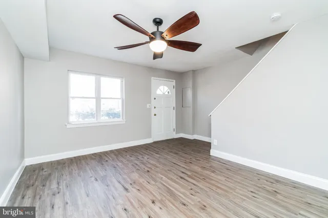 wooden floor in an empty room with a window