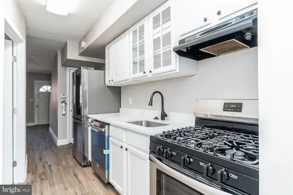 a kitchen with stainless steel appliances granite countertop a stove and a sink