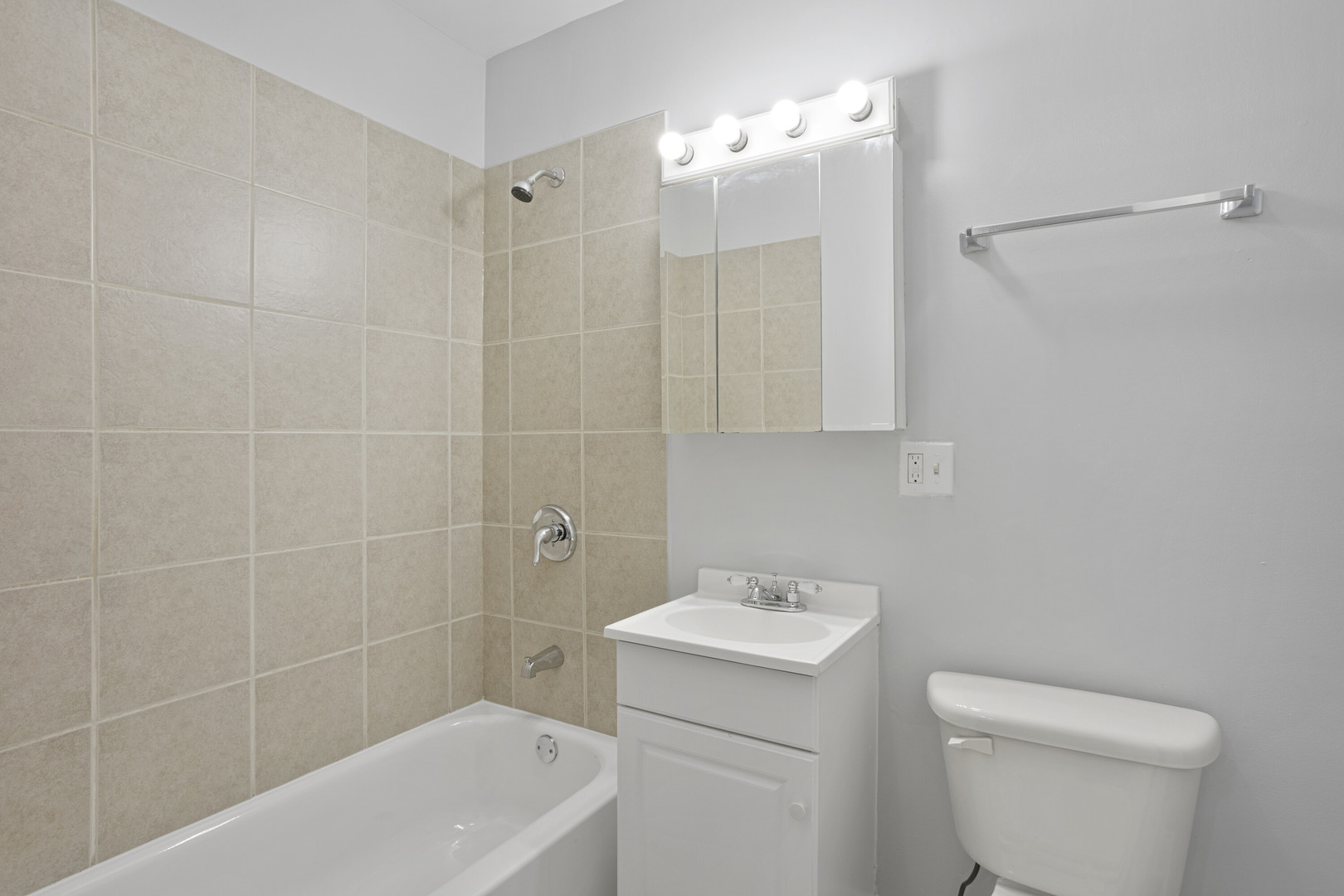 2005 West Jarvis Avenue, Unit 3 Chicago, IL 60645 - Photo 12 of 15 a bathroom with a sink a toilet and shower