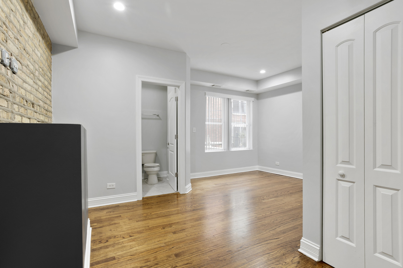 2005 West Jarvis Avenue, Unit 3 Chicago, IL 60645 - Photo 3 of 15 wooden floor in an empty room with a window