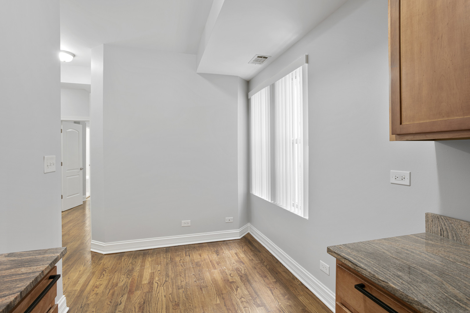 2005 West Jarvis Avenue, Unit 3 Chicago, IL 60645 - Photo 4 of 15 an empty room with wooden floor