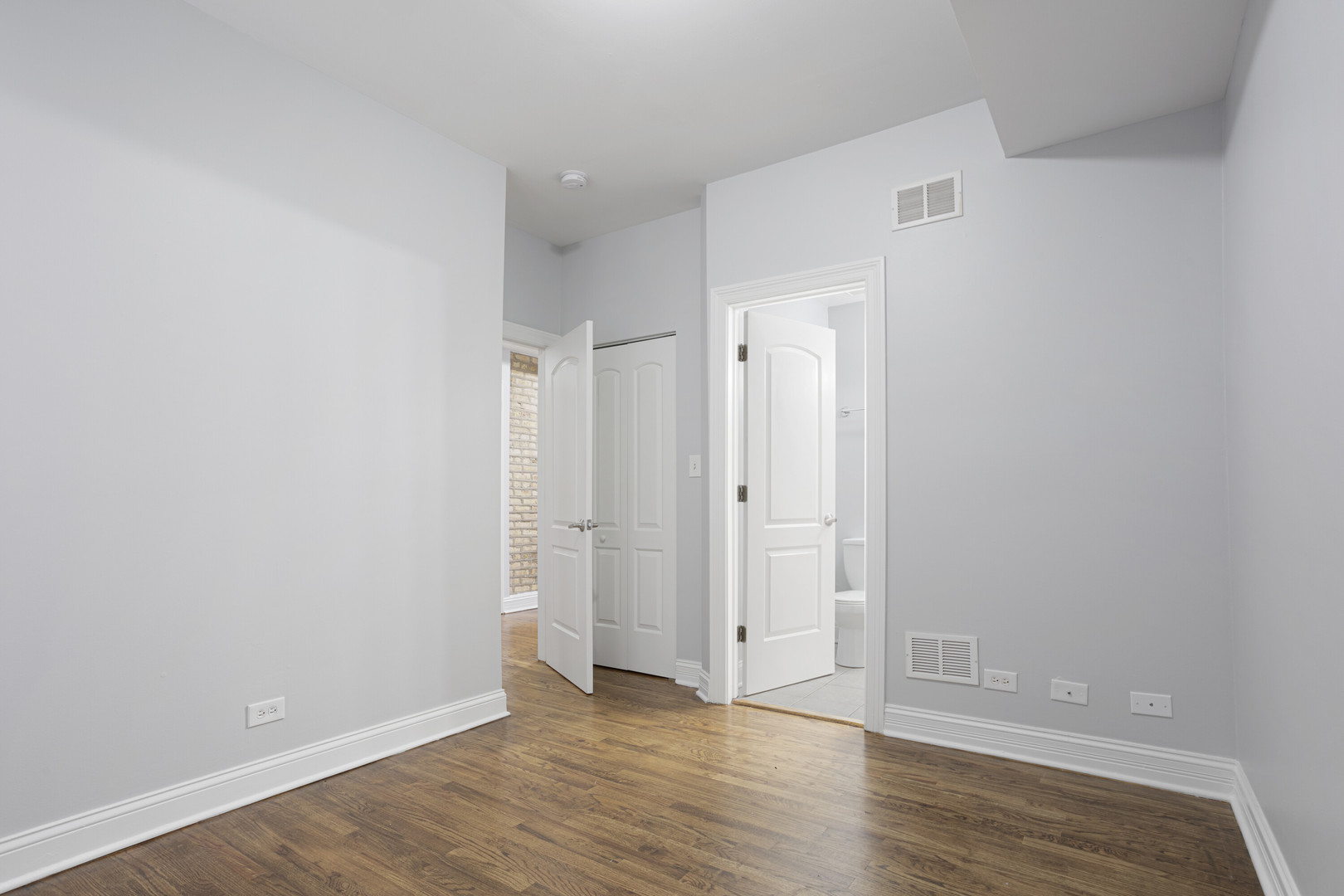 2005 West Jarvis Avenue, Unit 3 Chicago, IL 60645 - Photo 8 of 15 a view of an empty room and wooden floor