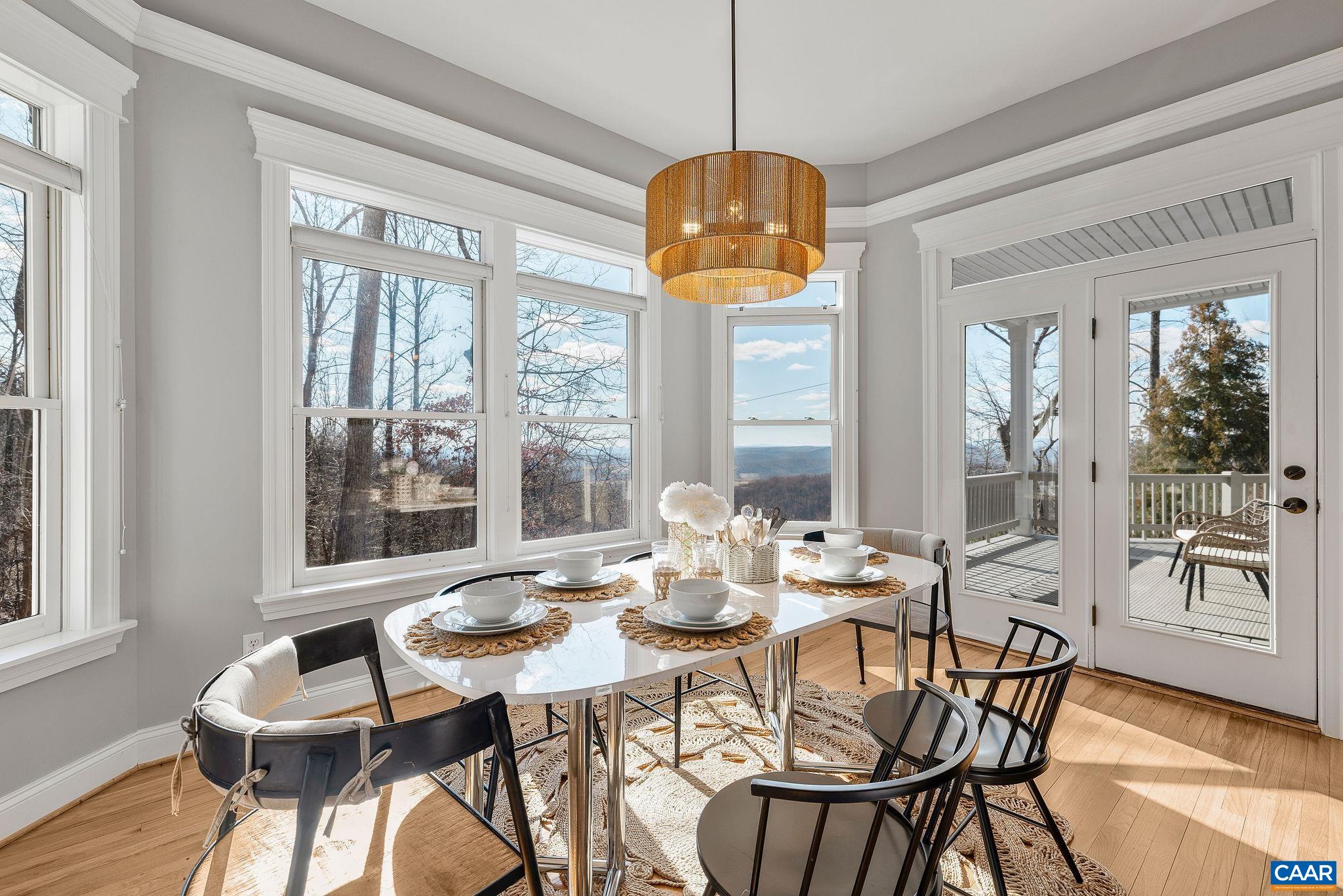 2556 Summit Ridge Trail Charlottesville, VA 22911 - Photo 40 of 75 a view of a dining room with furniture large windows wooden floor and front door