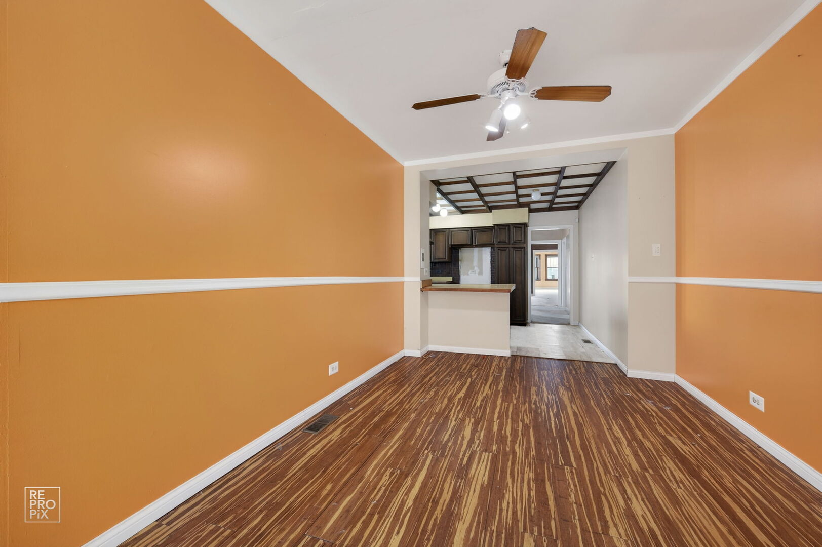 7236 South Michigan Avenue Chicago, IL 60619 - Photo 5 of 15 a view of a room with wooden floor and a ceiling fan