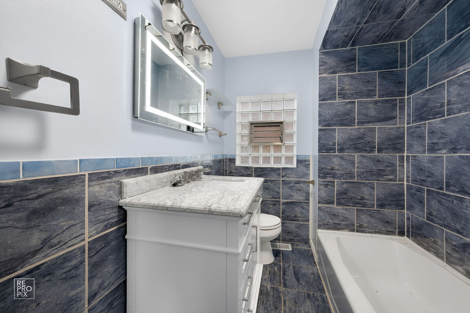 7236 South Michigan Avenue Chicago, IL 60619 - Photo 7 of 15 a bathroom with a granite countertop sink toilet and bathtub