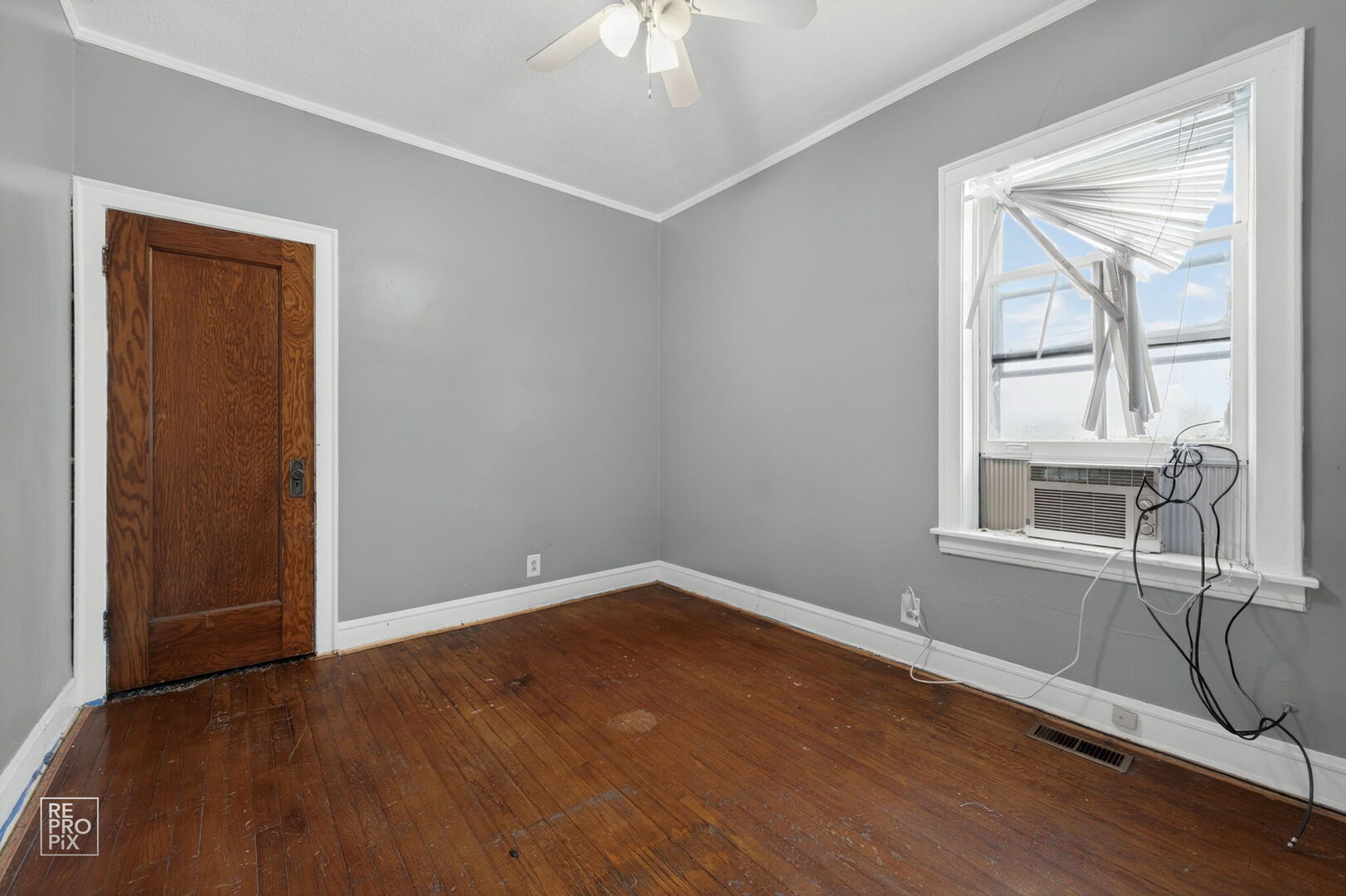 7236 South Michigan Avenue Chicago, IL 60619 - Photo 9 of 15 an empty room with a window and wooden floor