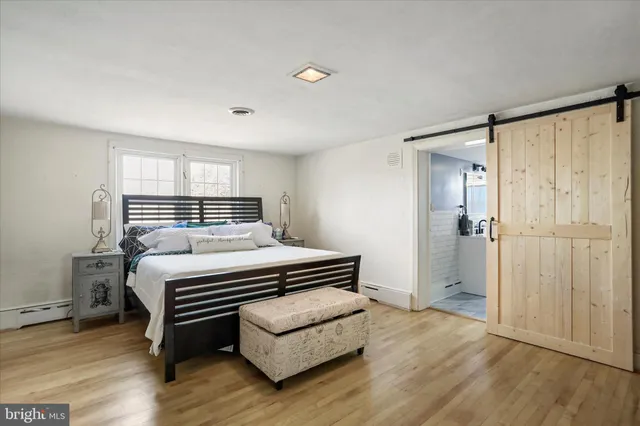 a bedroom with a bed and a mirror