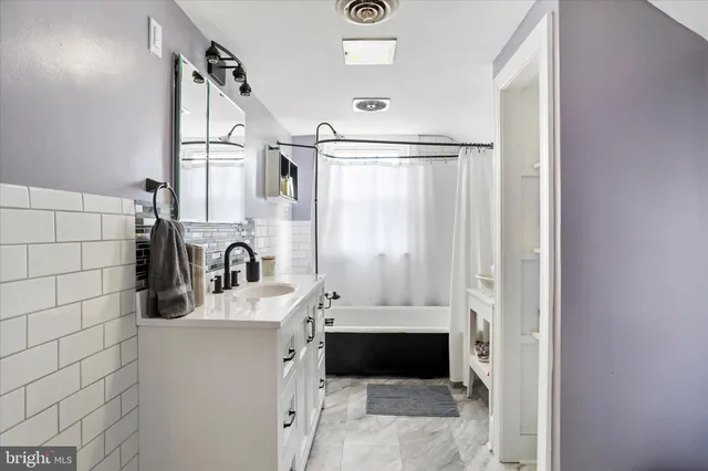 a bathroom with a sink a mirror and shower