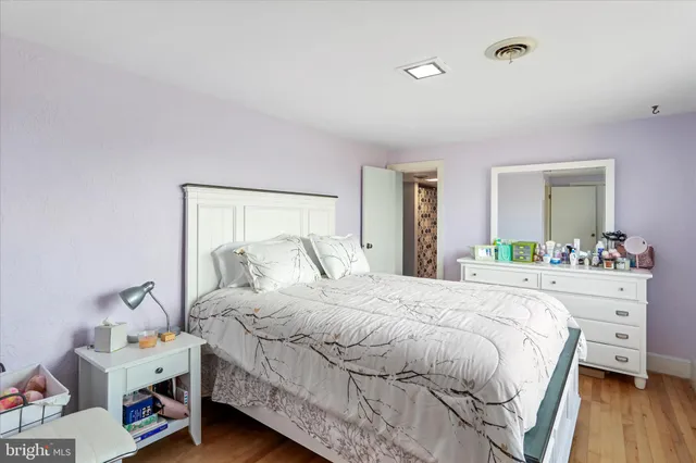 a bedroom with a bed and a mirror