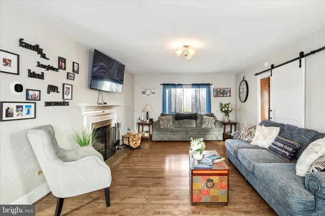 a living room with furniture fireplace and flat screen tv