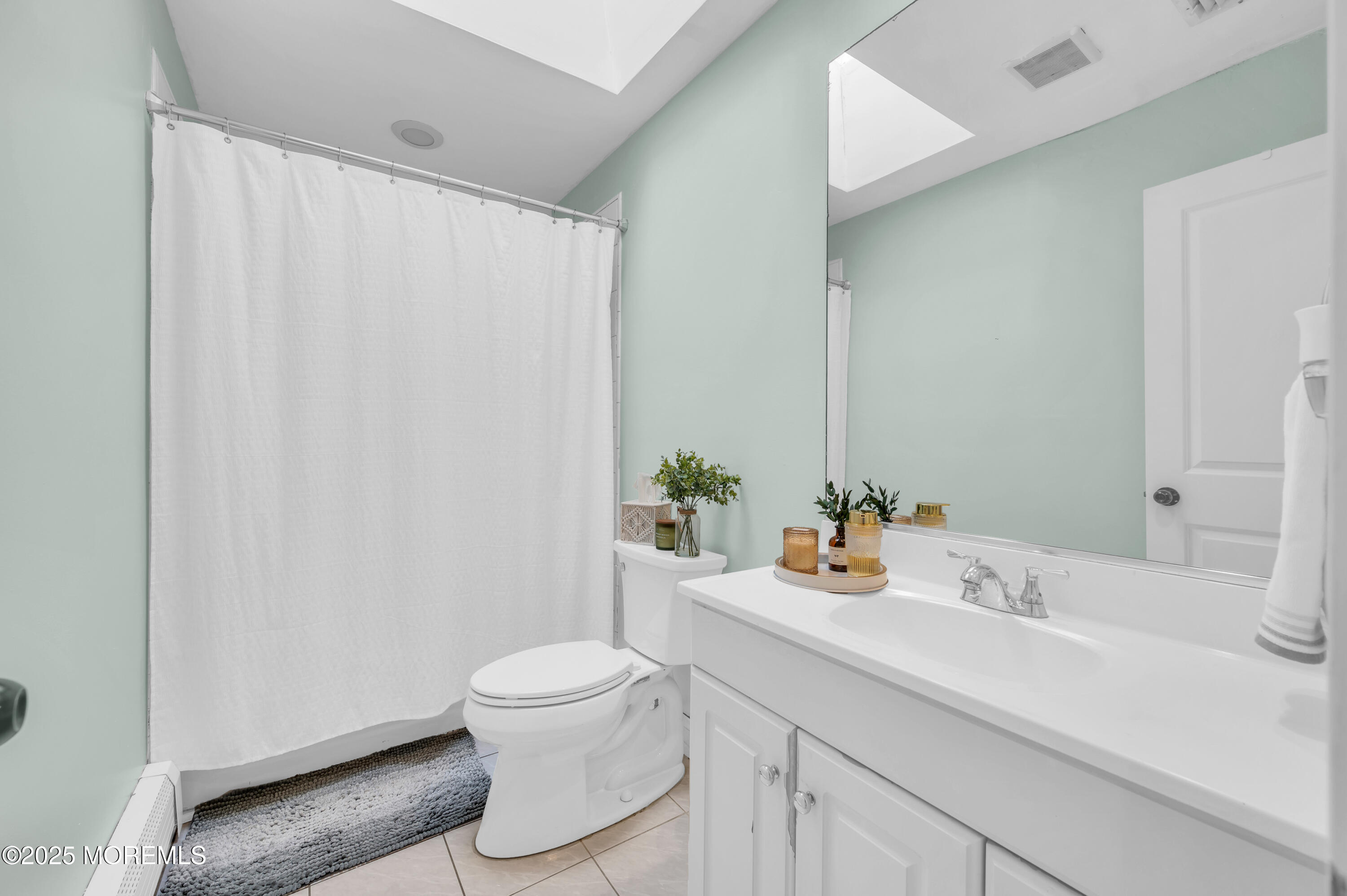 408 Cedar Drive Lanoka Harbor, NJ 08734 - Photo 27 of 39 a bathroom with a sink a toilet and shower curtain