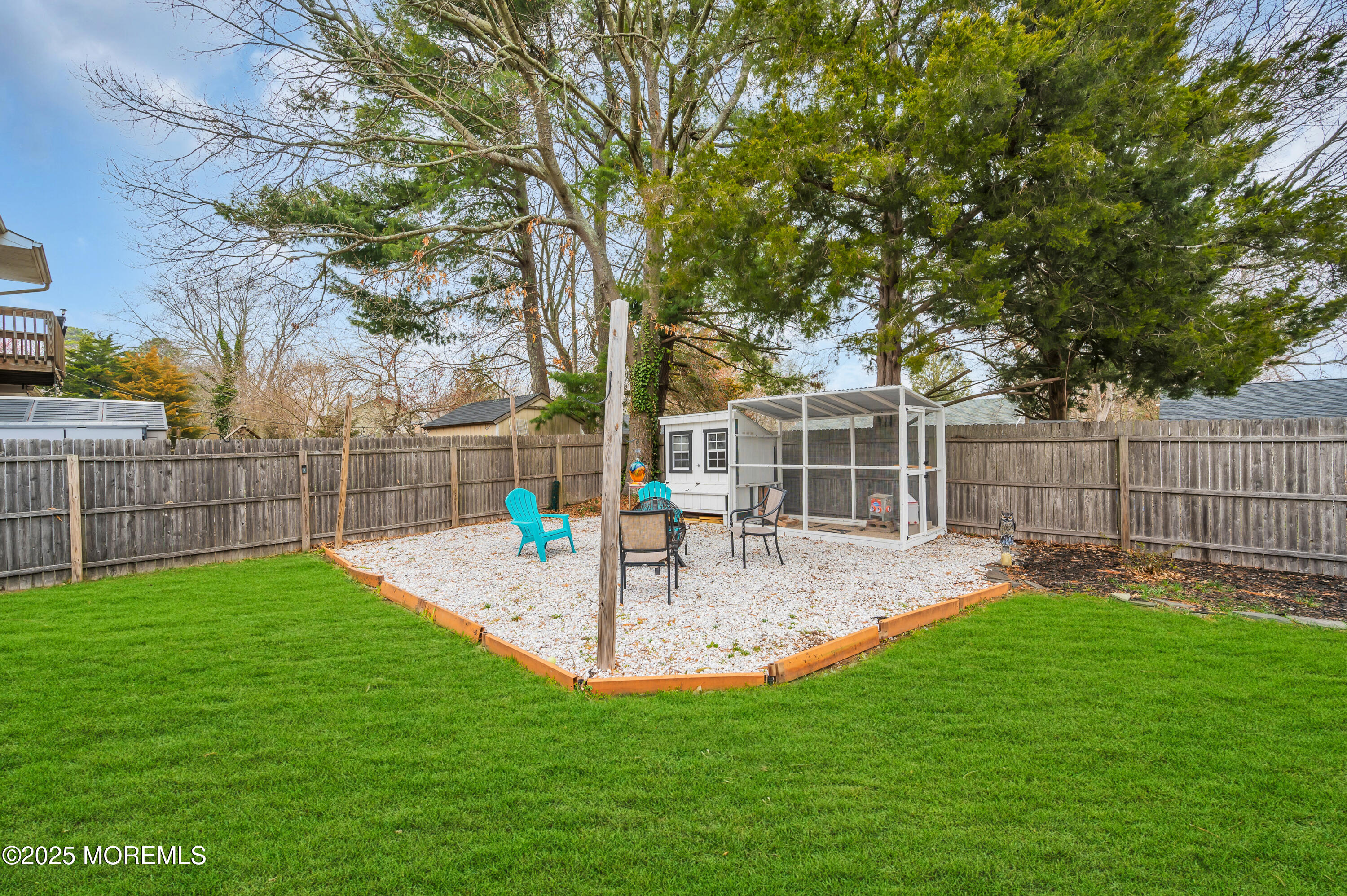 408 Cedar Drive Lanoka Harbor, NJ 08734 - Photo 34 of 39 a view of a backyard with table and chairs and wooden fence