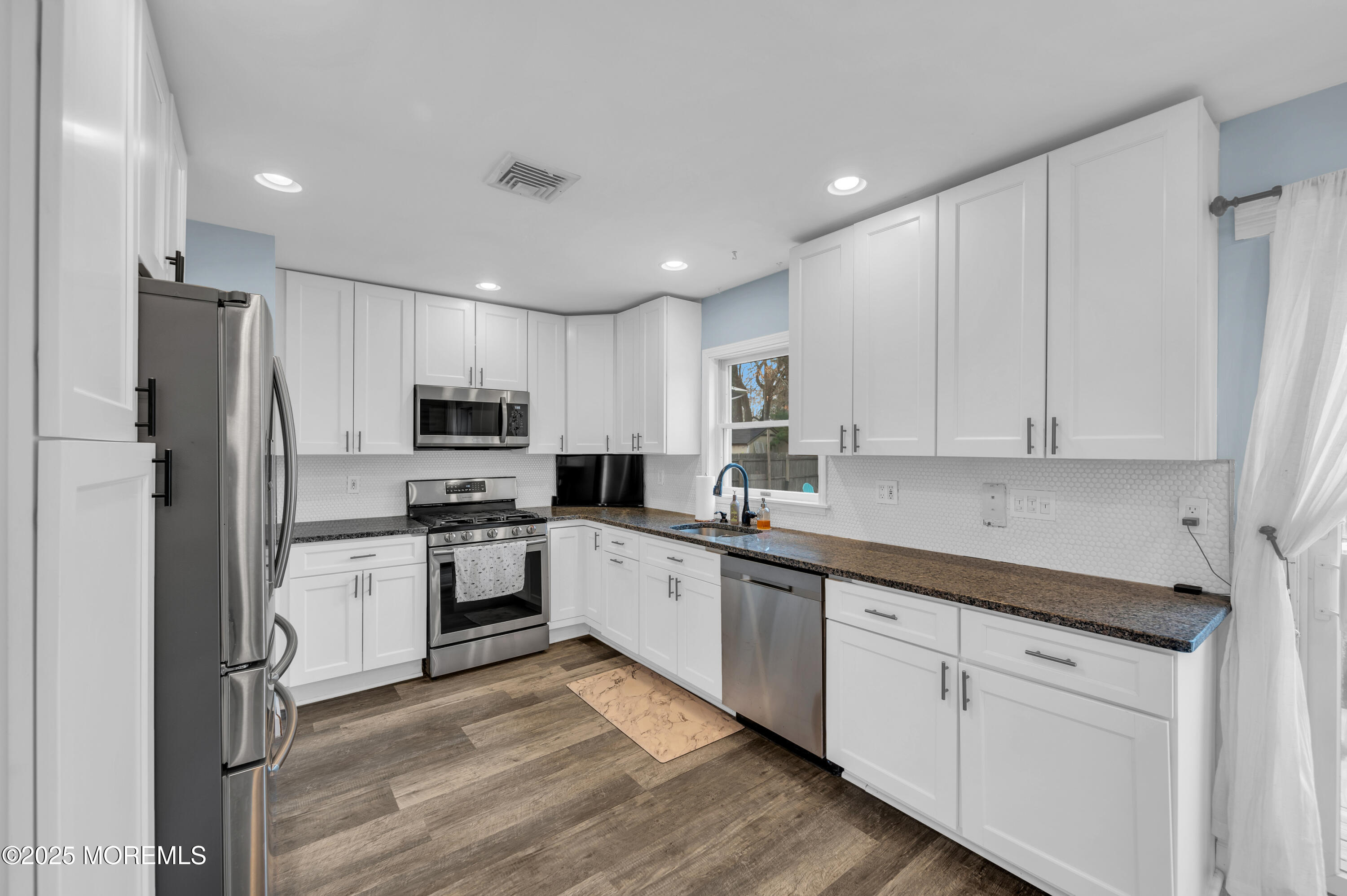 408 Cedar Drive Lanoka Harbor, NJ 08734 - Photo 10 of 39 a kitchen with white cabinets and stainless steel appliances