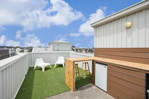 a roof deck with table and chairs