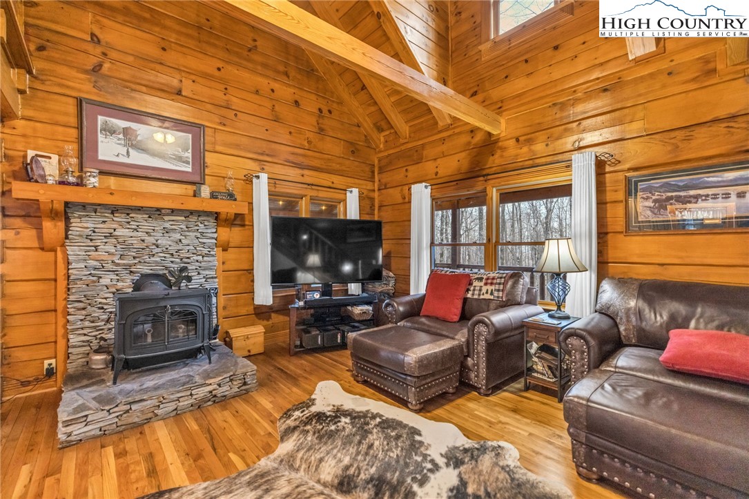 632 Big Tree Road West Jefferson, NC 28694 - Photo 15 of 48 a living room with furniture a fireplace and a flat screen tv