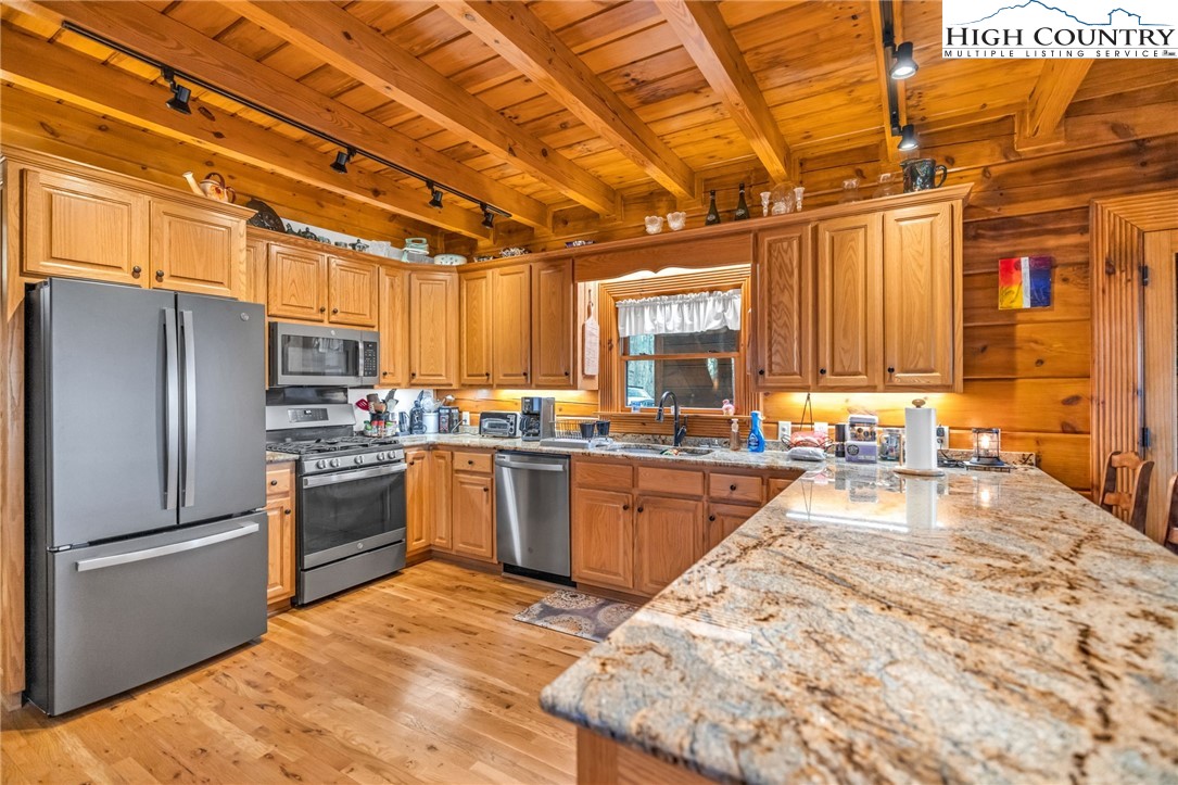 632 Big Tree Road West Jefferson, NC 28694 - Photo 17 of 48 a kitchen with granite countertop a sink stainless steel appliances and cabinets