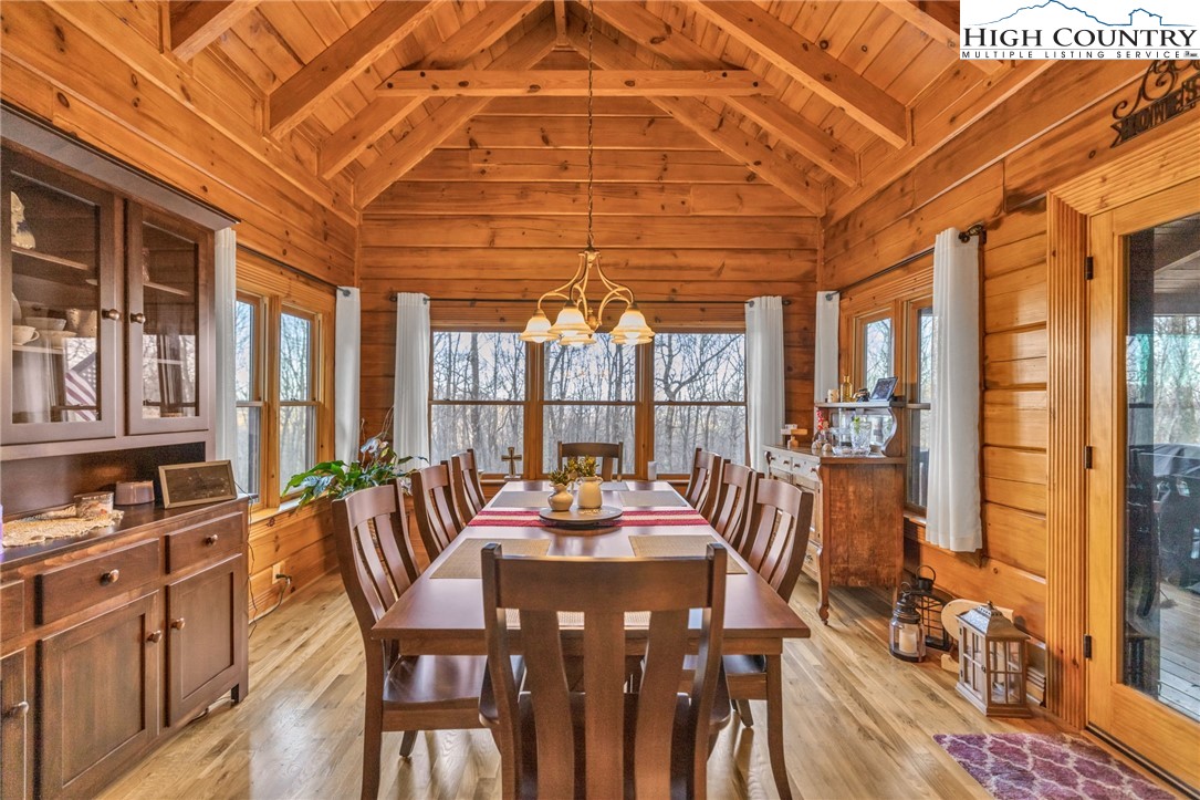 632 Big Tree Road West Jefferson, NC 28694 - Photo 22 of 48 a view of a dining room with furniture a chandelier and wooden floor