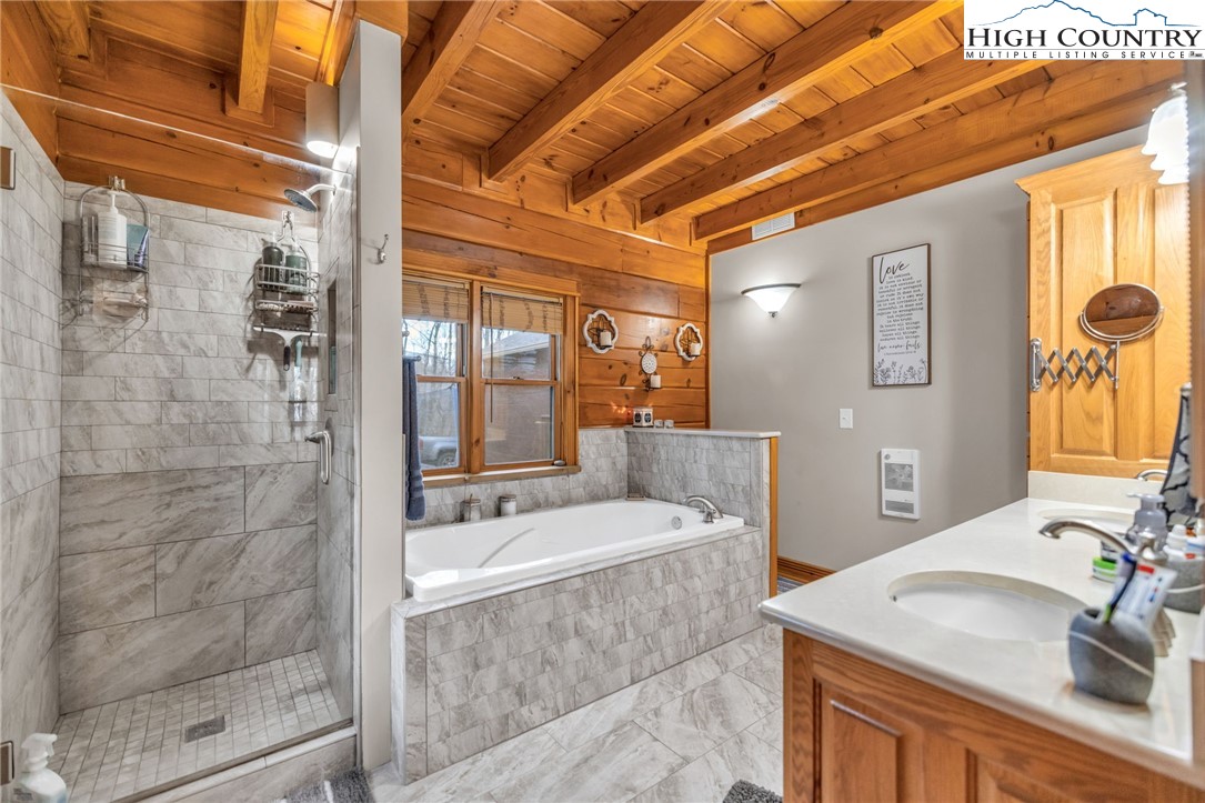 632 Big Tree Road West Jefferson, NC 28694 - Photo 26 of 48 a bathroom with a sink a mirror and a shower