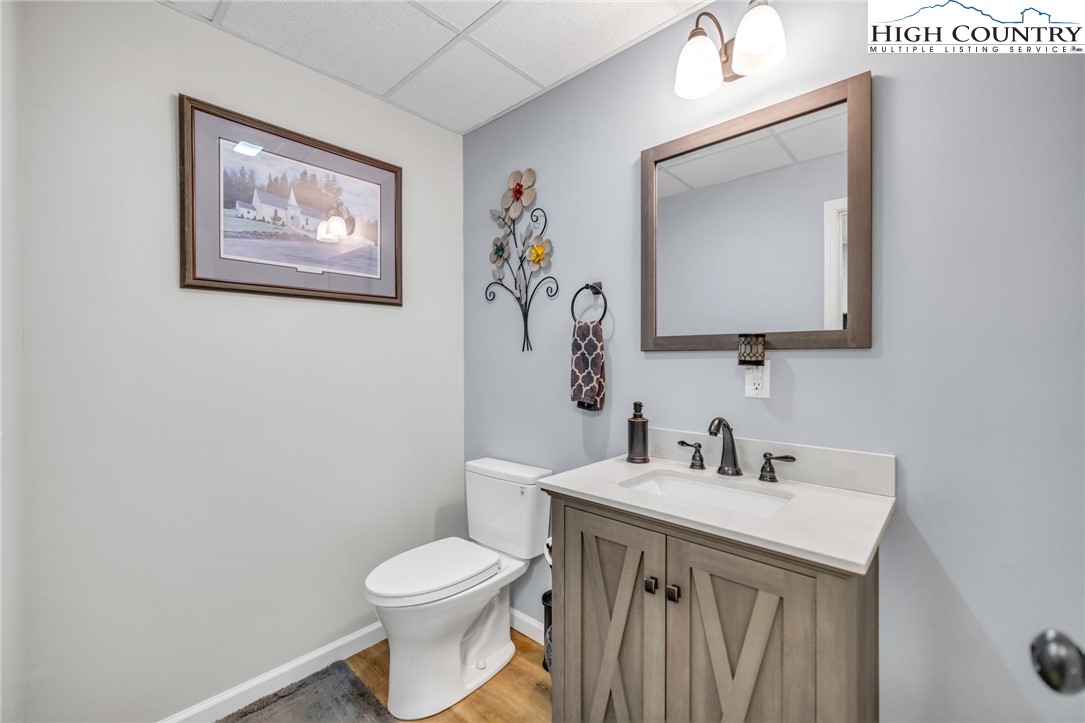 632 Big Tree Road West Jefferson, NC 28694 - Photo 38 of 48 a bathroom with a toilet a sink and mirror