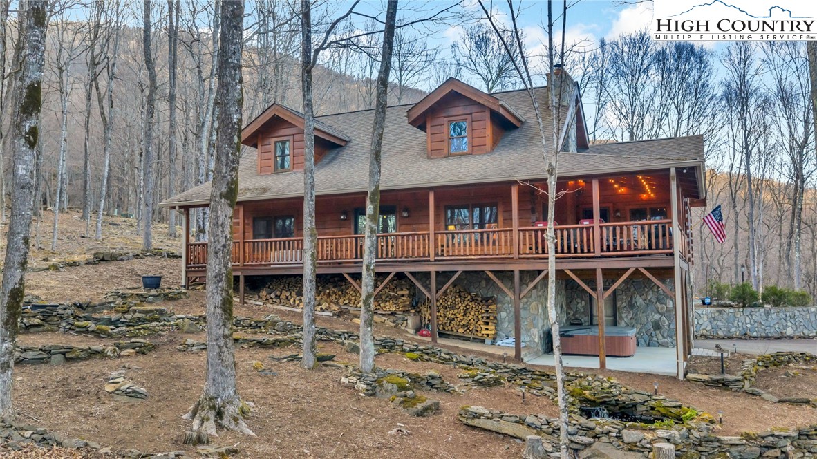 632 Big Tree Road West Jefferson, NC 28694 - Photo 44 of 48 a front view of a house with large windows and wooden fence