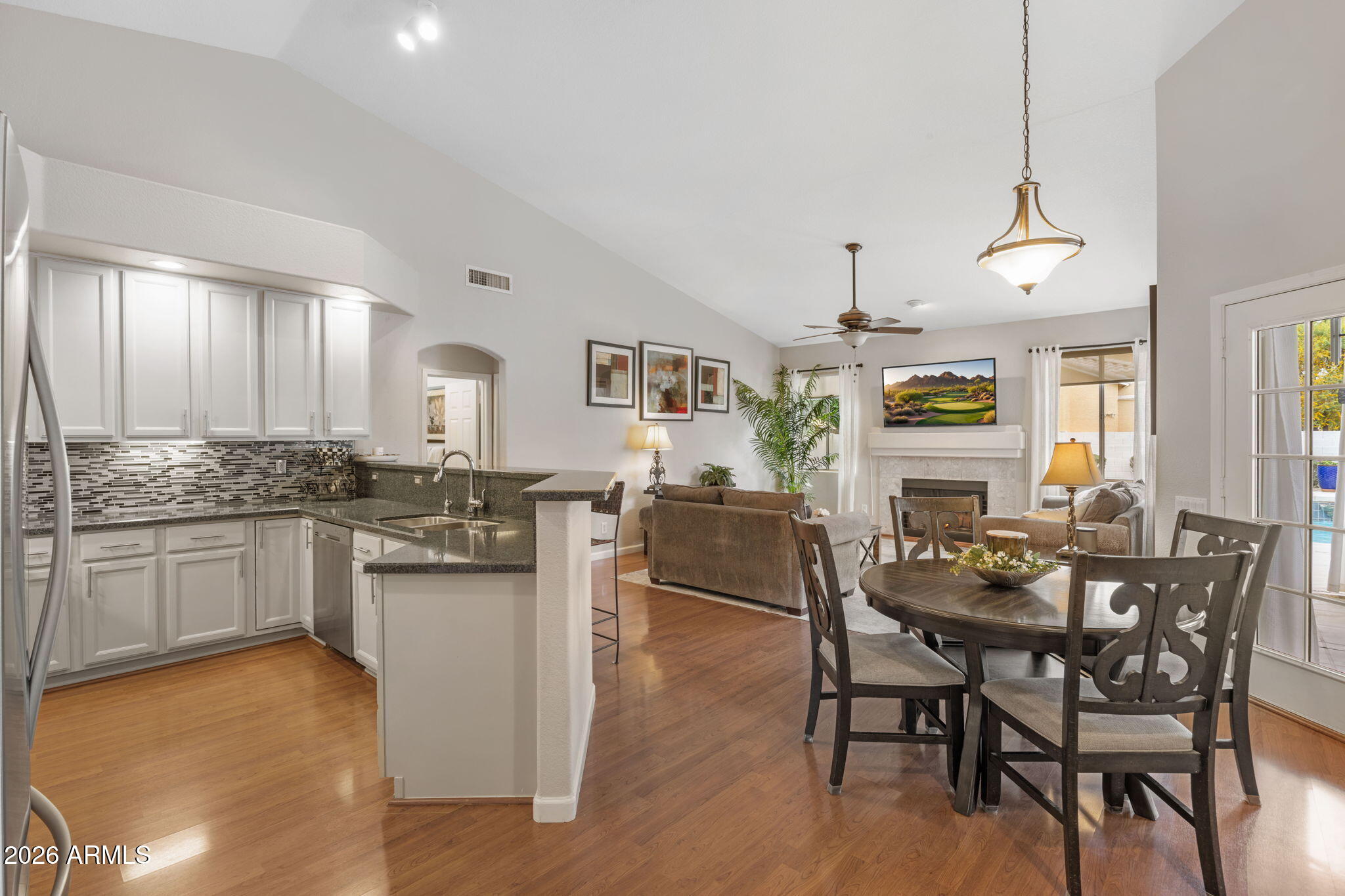 16008 South 38th Way Phoenix, AZ 85048 - Photo 12 of 47 a view of a dining room with furniture and wooden floor