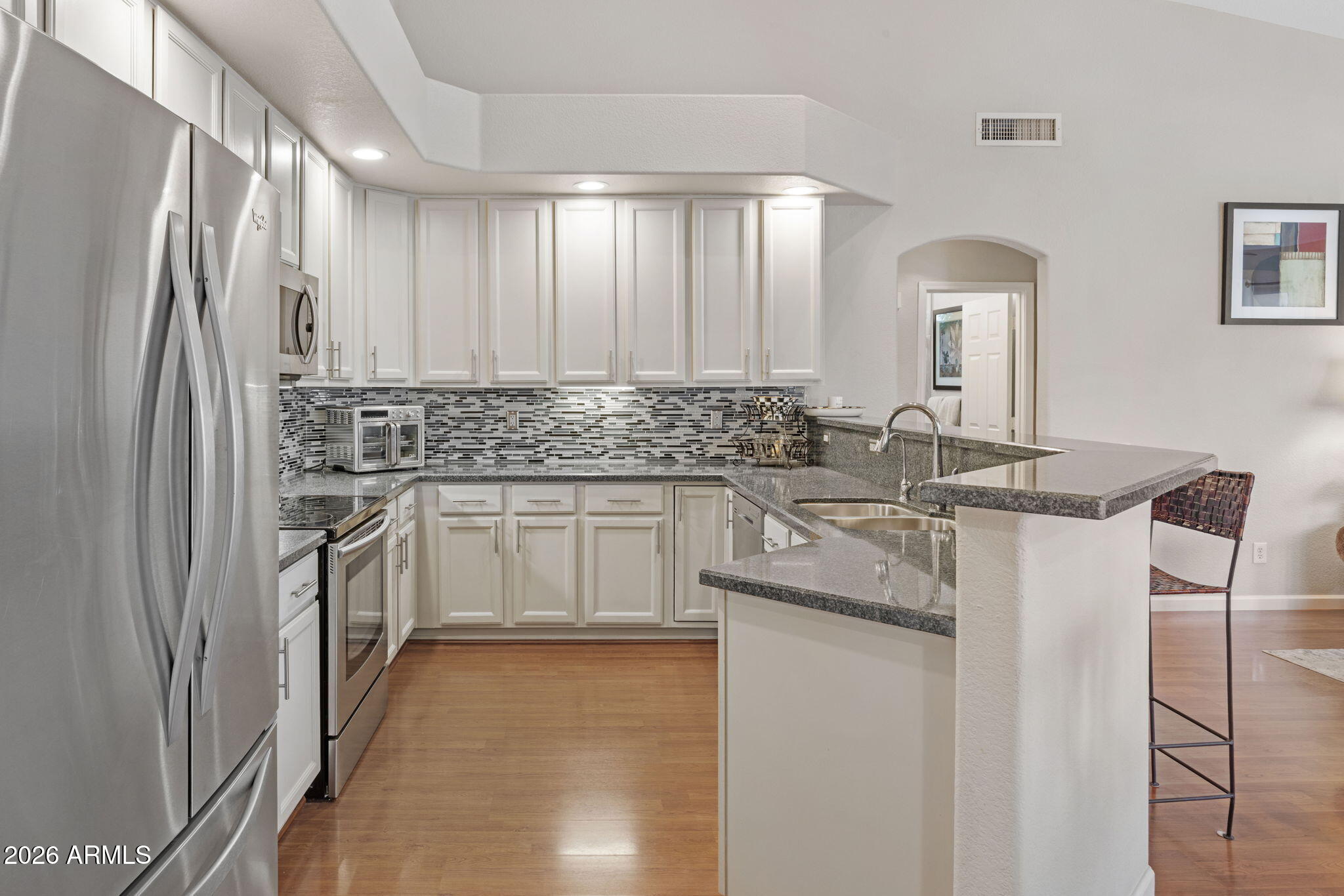 16008 South 38th Way Phoenix, AZ 85048 - Photo 13 of 47 a kitchen with kitchen island a sink stove and refrigerator
