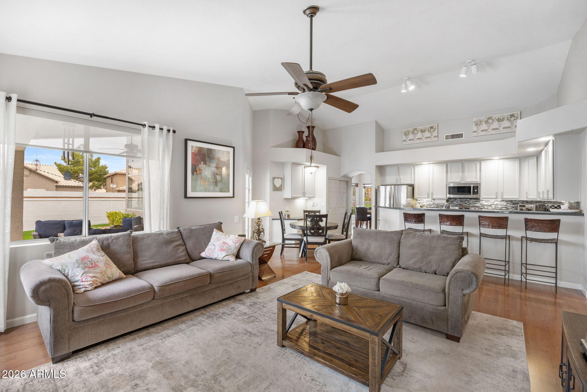 16008 South 38th Way Phoenix, AZ 85048 - Photo 16 of 47 a living room with furniture kitchen view and a chandelier