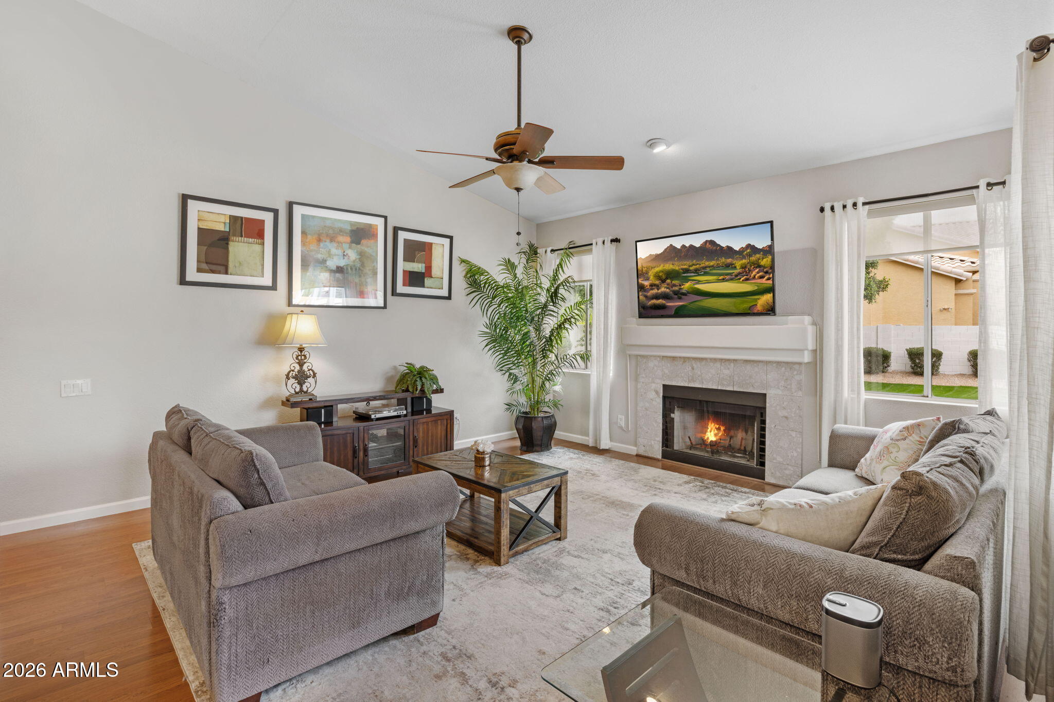 16008 South 38th Way Phoenix, AZ 85048 - Photo 19 of 47 a living room with furniture a fireplace and a flat screen tv