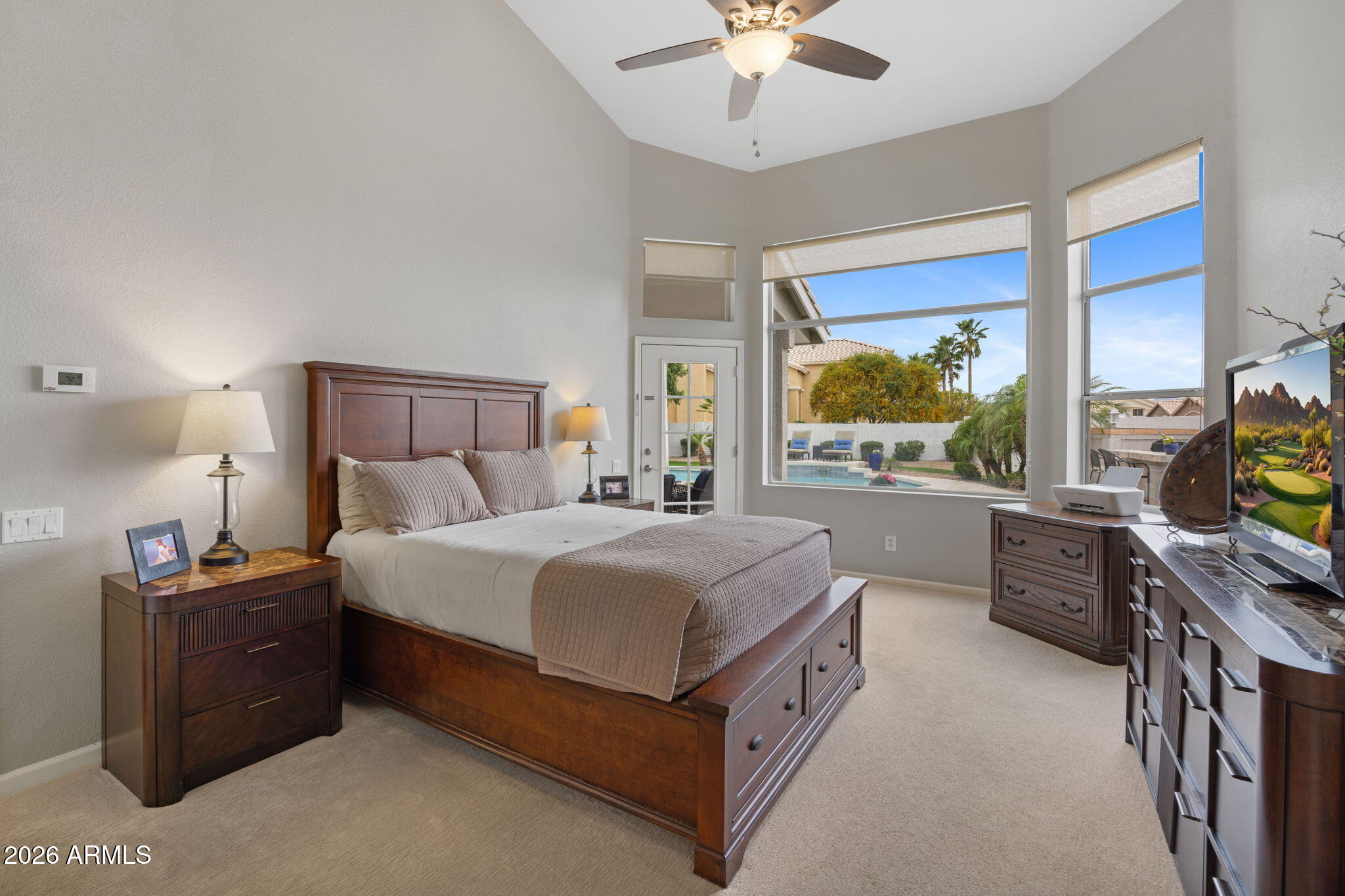 16008 South 38th Way Phoenix, AZ 85048 - Photo 21 of 47 a bedroom with a bed and a flat tv screen on dresser