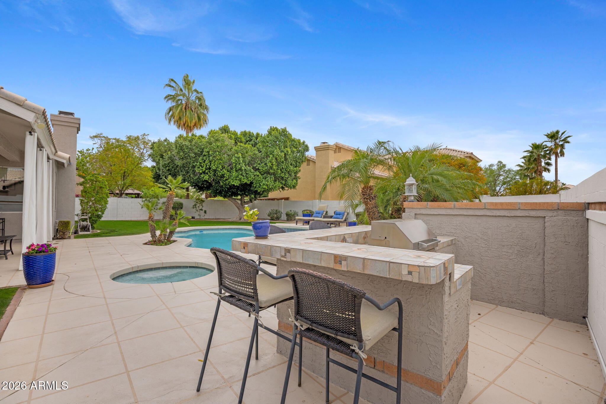 16008 South 38th Way Phoenix, AZ 85048 - Photo 43 of 47 a view of a patio with couches and table and chairs and potted plants