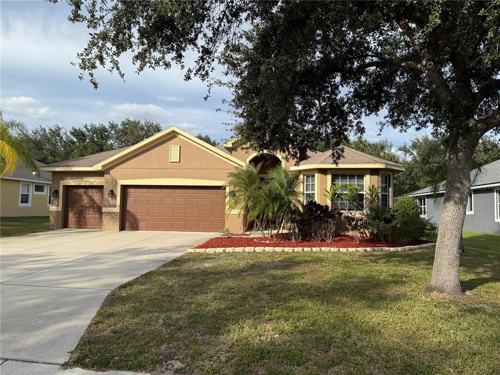 a front view of a house with a yard and garage