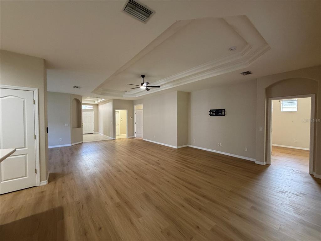 12418 24th Street East Parrish, FL 34219 - Photo 20 of 59 an empty room with wooden floor and windows